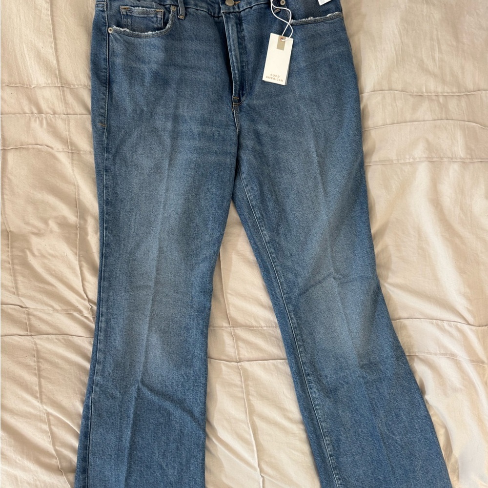 Good American soft tech slim bootcut jeans, light indigo blue